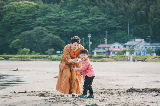 istock Boy handing mother a carnation flower 1219363060