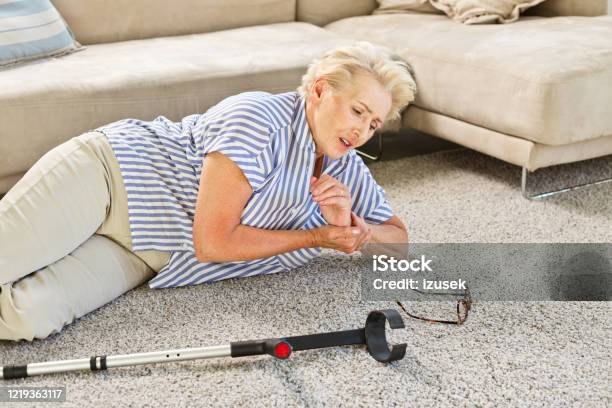Elderly Lady Lying On The Floor After Moving Down Stock Photo - Download Image Now - Senior Adult, Falling, Broken Leg