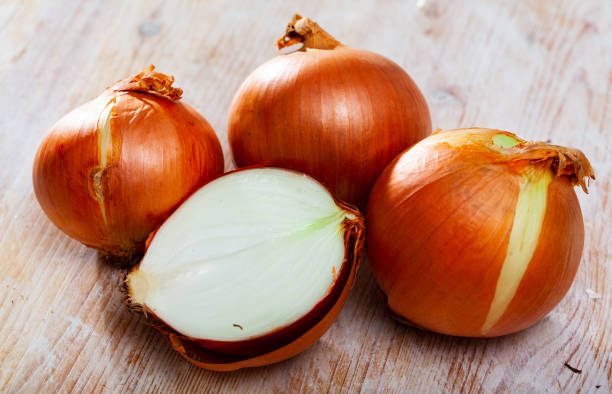 istock Ripe white onion on wooden table 1219363472