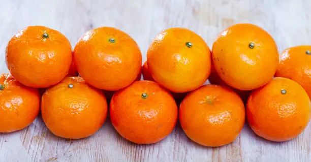 Photo of Clementines on wooden background