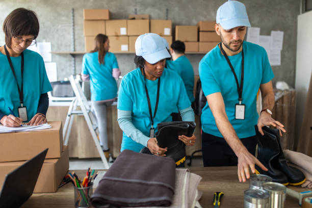 istock Group of friends working at charitable foundation 1219364144