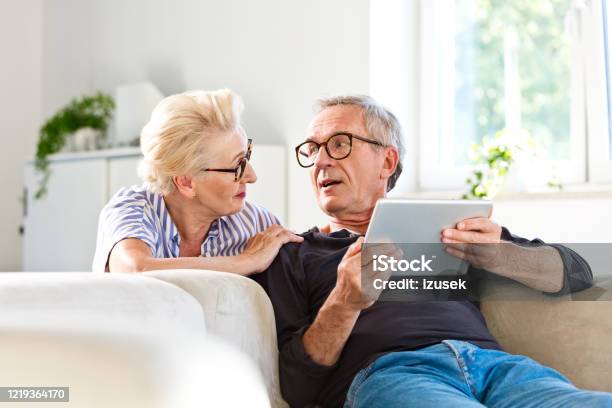 Senior Couple Spending Time Together At Home Stock Photo - Download Image Now - Home Interior, Domestic Life, Digital Tablet