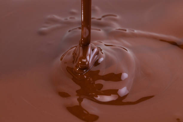 istock Melted chocolate swirl background. Liquid chocolate close-up 1219364179