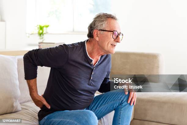 Senior Man Suffering Backache Stock Photo - Download Image Now - Backache, Pain, Chronic Illness