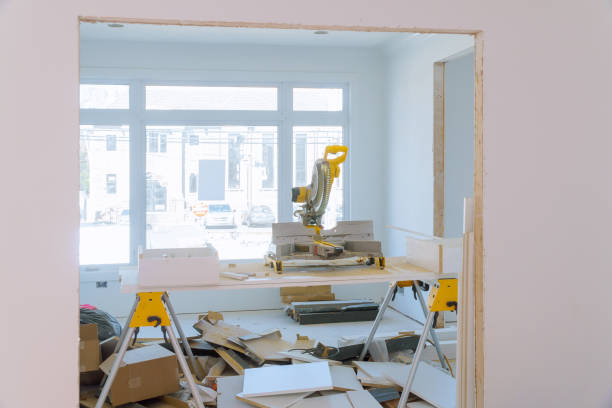istock Construction remodeling home cutting wooden trim molding on with circular saw. 1219364779
