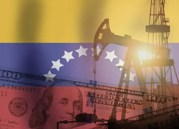 Crude oil and petroleum concept. Pump jack, US dollar notes and Venezuela flag background