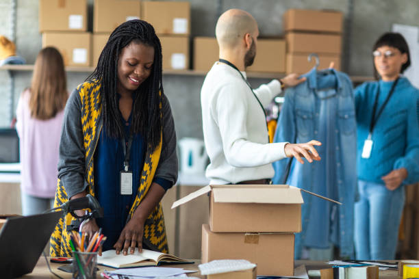 istock Workers checking the shipment list and packing clothes for delivery 1219364849
