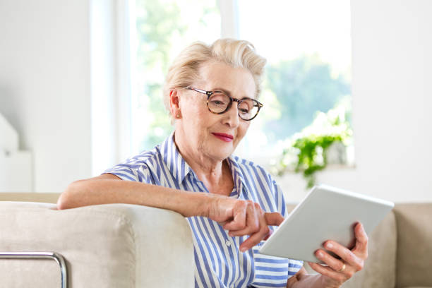 istock Senior woman using digital tablet together at home 1219364875