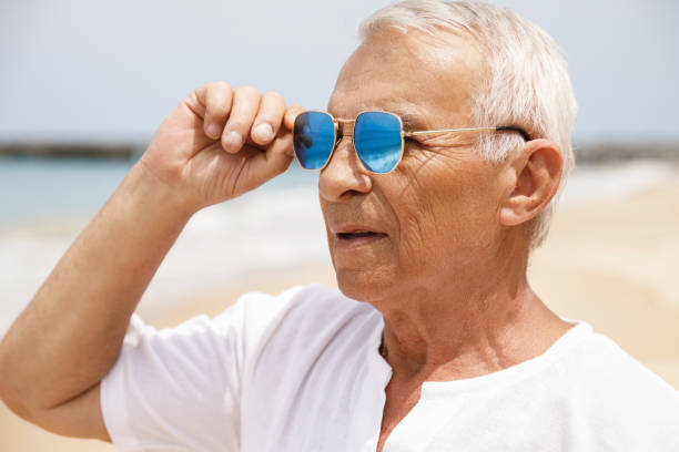 istock Happy senior man walking on the beach 1219365004