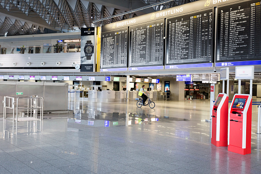 Frankfurt, Germany - April 17, 2020: Empty departure terminal hall at Frankfurt International Airport. Usually Frankfurt Airport is one of the busiest airports in Europe. As a result of the coronavirus pandemic and social distancing, airports around the world have emptied out as they deal with a dramatic drop in air traffic.