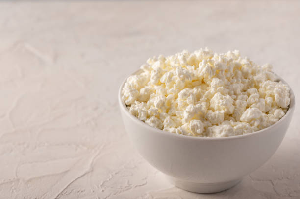 istock Curd in a bowl close-up on a light background 1219368447