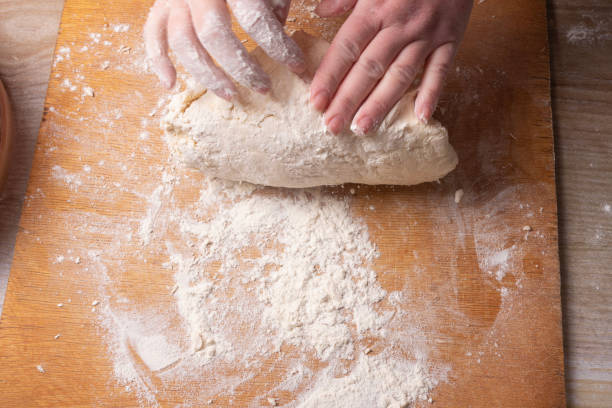 istock Female hands mixing dough in the home kitchen. 1219368493