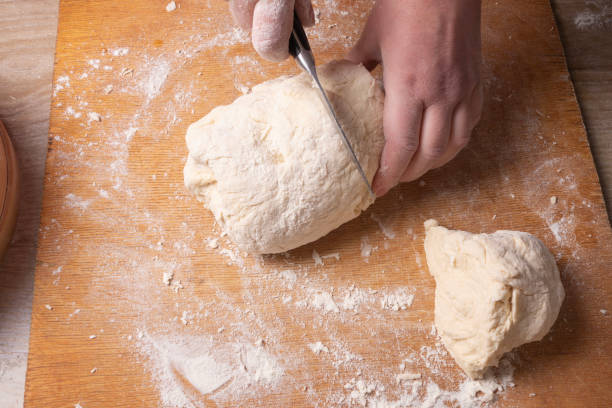 istock Female hands mixing dough in the home kitchen. 1219368510