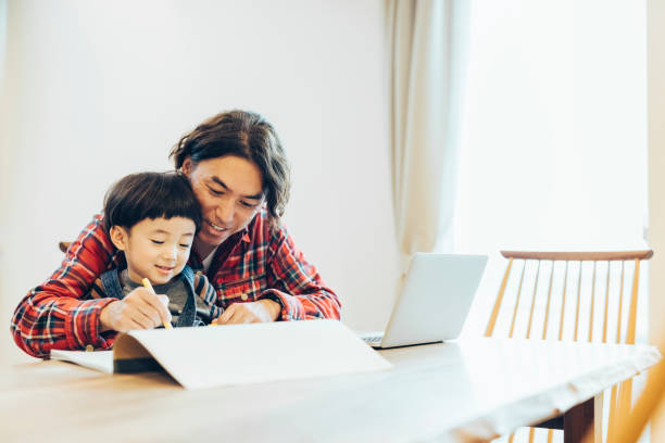 istock Father and Son Drawing together 1219368887