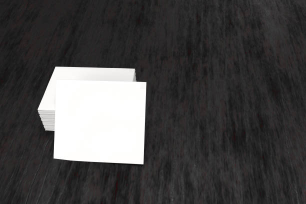 istock 3d render of white business card stack mockup on dark wood textured matte base background. 1219371019