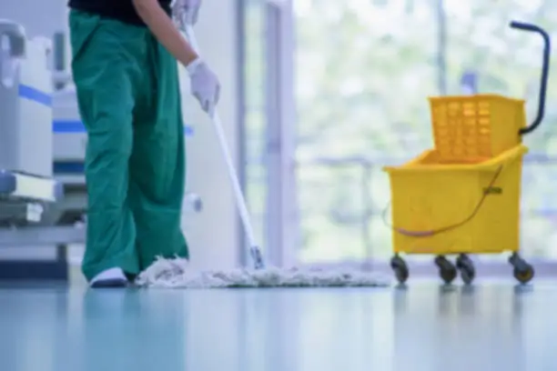 Photo of Floor care and cleaning services with washing mop in sterile factory or clean hospital.