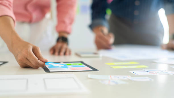 istock Graphic designers team work together with UX UI designer planning application template layout mobile phone prototype, User experience concept. 1219374272