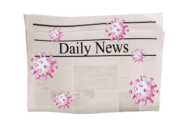 istock Coronavirus Covid-19 news. Newspaper with headline Daily News on horizontal surface with flying virus 1219375821