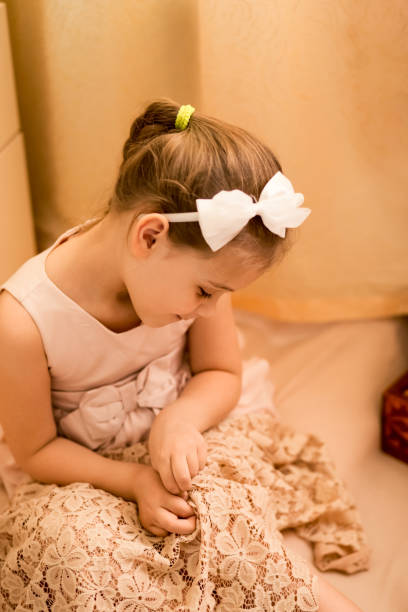 istock little girl is engaged in sewing at home, needlework 1219376102