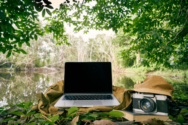 istock Working outdoors, refreshing working ideas with laptops and cameras in green forests and rivers 1219376132