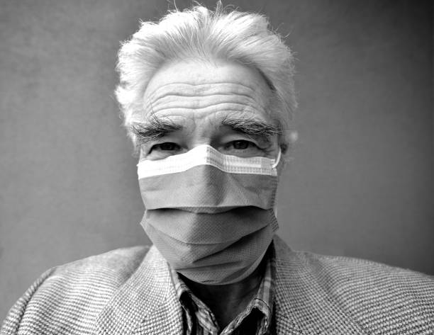 istock senior man's portrait with a mask 1219376200
