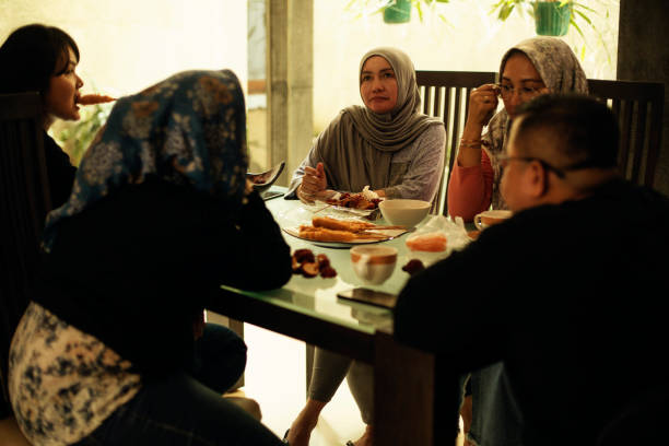 istock happy asian friends having iftar together 1219378366