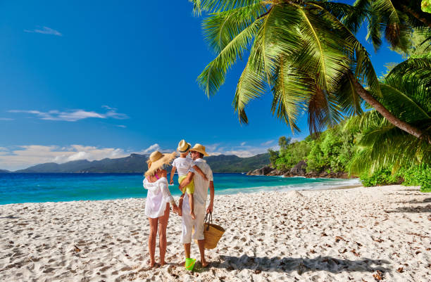 Family with three year old boy on beach. Seychelles, Mahe.