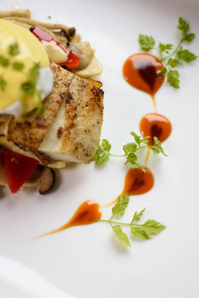 istock Pan fried dory fish topped with egg Benedict and heart shape dressing 1219378479