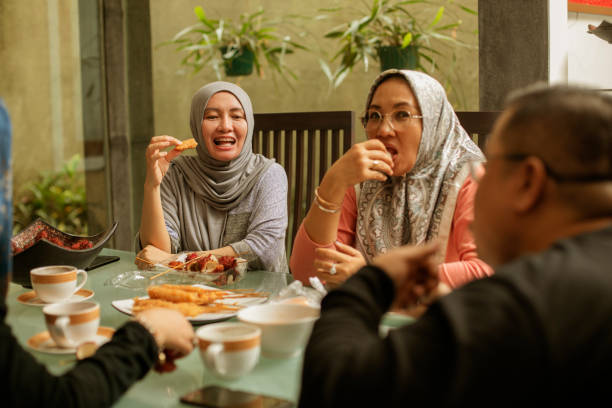 istock happy asian friends having iftar together 1219378869