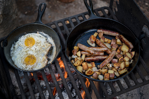 Photograph of a cast iron skillet full of fresh eggs ready for breakfast.