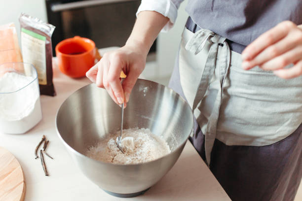 istock A woman pastry chef or baker preparing a cake. 1219382349