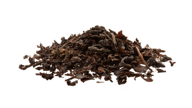 istock Dry black tea leaves isolated on white background 1219384950