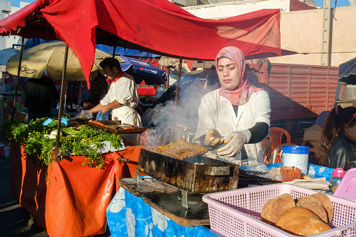 Casablanca, Morocco - February 18, 2016: Locals grill meat and prepare food at their street food stalls along streets of Casablanca’s Old Medina.