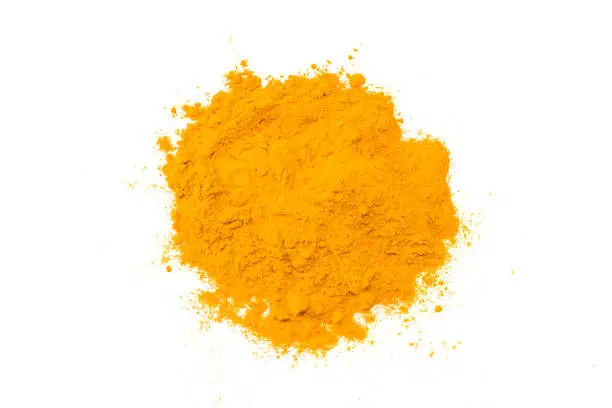 Turmeric powder isolated on white background. Top view.
