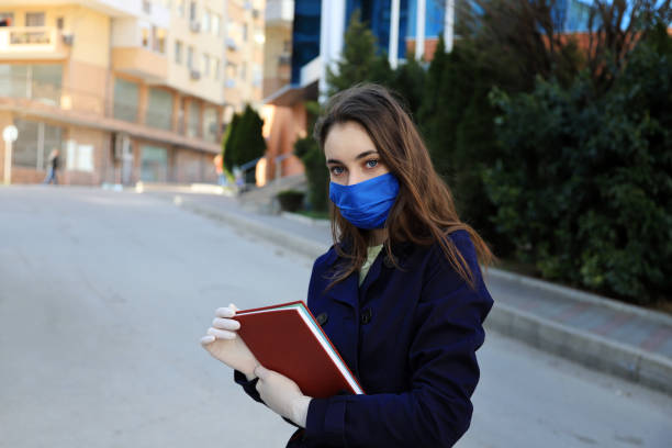 istock Young woman wearing face-protective mask and gloves 1219386420