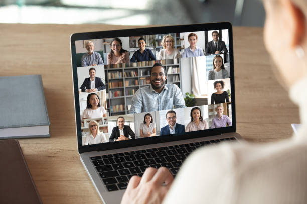 Female employee talk on video call with colleagues Back view of female employee speak talk on video call with diverse multiracial colleagues on online briefing, woman worker have Webcam group conference with coworkers on modern laptop at home conference call stock pictures, royalty-free photos & images