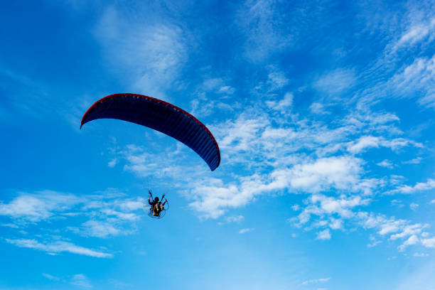 istock Silhouette of Paragliding flying  on Sky background 1219386630