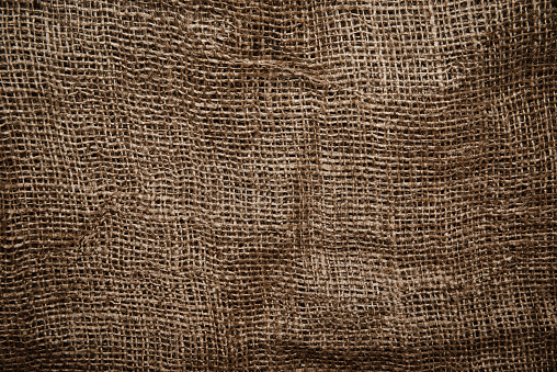 Jute sack texture. Background made of brown jute material.
