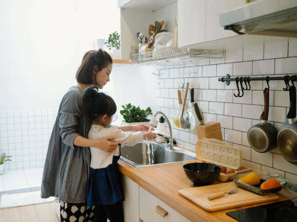 istock Happy asian family in the kitchen. 1219391049