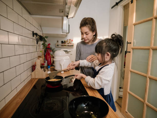 istock Happy asian family in the kitchen. 1219391120