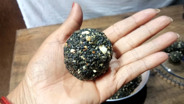bolas de semillas de sésamo negro - dulce hecha con sésamo y azúcar de palma. - peanut bowl nut circle fotografías e imágenes de stock