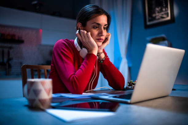 istock A female working on a laptop during a viral outbreak at her home at night 1219392975