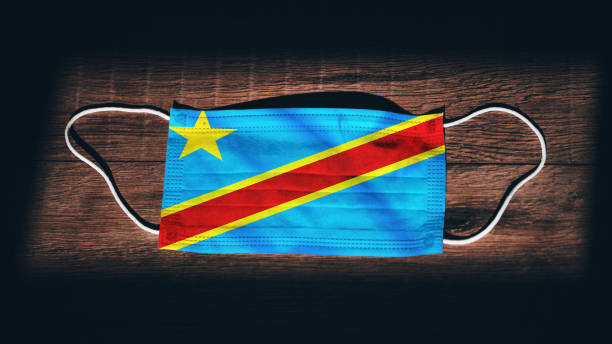 Congo, Democratic Republic of the National Flag at medical, surgical, protection mask on black wooden background. Coronavirus Covid"u201319, Prevent infection, illness or flu State of Emergency, Lockdown... Congo, Democratic Republic of the National Flag at medical, surgical, protection mask on black wooden background. Coronavirus Covid"u201319, Prevent infection, illness or flu State of Emergency, Lockdown... kinshasa stock pictures, royalty-free photos & images