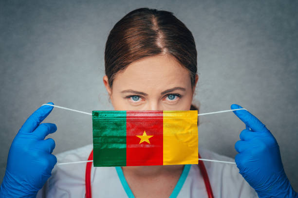 Coronavirus in Cameroon Female Doctor Portrait hold protect Face surgical medical mask with Cameroon National Flag. Illness, Virus Covid-19 in Cameroon, concept photo Coronavirus in Cameroon Female Doctor Portrait hold protect Face surgical medical mask with Cameroon National Flag. Illness, Virus Covid-19 in Cameroon, concept photo yaounde photos stock pictures, royalty-free photos & images