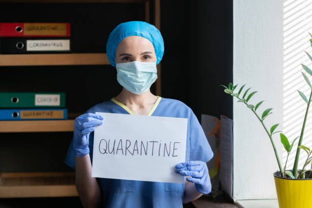 medico donna in uniforme blu dichiara quarantena - surgeon isolated paramedic operating room foto e immagini stock
