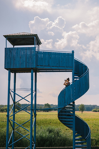 Young Caucasian woman standing on lookout  tower