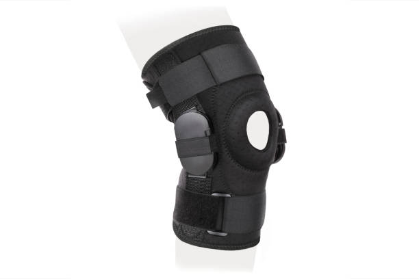 Knee Support Brace on leg isolated on white background. Orthopedic Anatomic Orthosis. Braces for knee fixation, injuries and pain. Orthotics. Foot orthosis. Knee Joint Bandage Sleeve. Elastic Sports Knee Support Brace on leg isolated on white background. Orthopedic Anatomic Orthosis. Braces for knee fixation, injuries and pain. Orthotics. Foot orthosis. Knee Joint Bandage Sleeve. Elastic Sports kneepad stock pictures, royalty-free photos & images