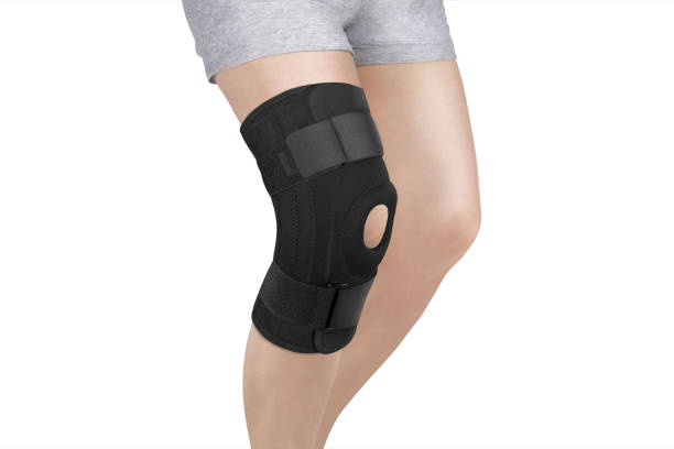 Knee Support Brace on leg isolated on white background. Orthopedic Anatomic Orthosis. Braces for knee fixation, injuries and pain. Orthotics. Foot orthosis. Knee Joint Bandage Sleeve. Elastic Sports Knee Support Brace on leg isolated on white background. Orthopedic Anatomic Orthosis. Braces for knee fixation, injuries and pain. Orthotics. Foot orthosis. Knee Joint Bandage Sleeve. Elastic Sports knee brace stock pictures, royalty-free photos & images