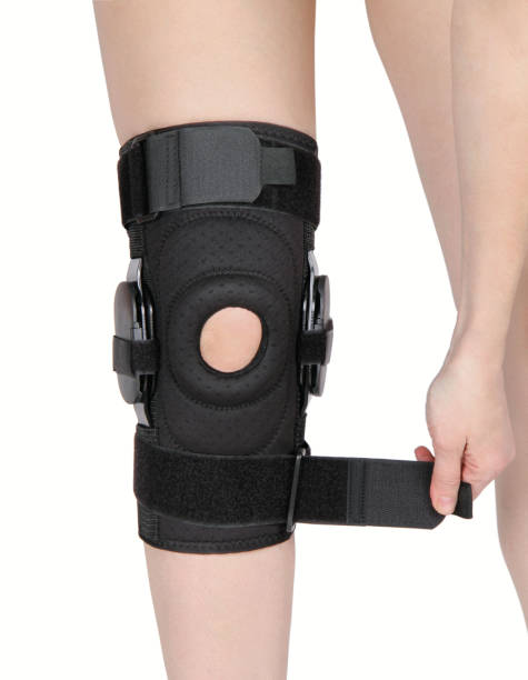 Knee Support Brace on leg isolated on white background. Orthopedic Anatomic Orthosis. Braces for knee fixation, injuries and pain. Orthotics. Foot orthosis. Knee Joint Bandage Sleeve. Elastic Sports Knee Support Brace on leg isolated on white background. Orthopedic Anatomic Orthosis. Braces for knee fixation, injuries and pain. Orthotics. Foot orthosis. Knee Joint Bandage Sleeve. Elastic Sports artificial knee photos stock pictures, royalty-free photos & images
