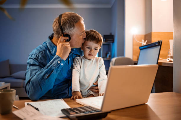istock He's working but still keeps an eye on his son 1219403137